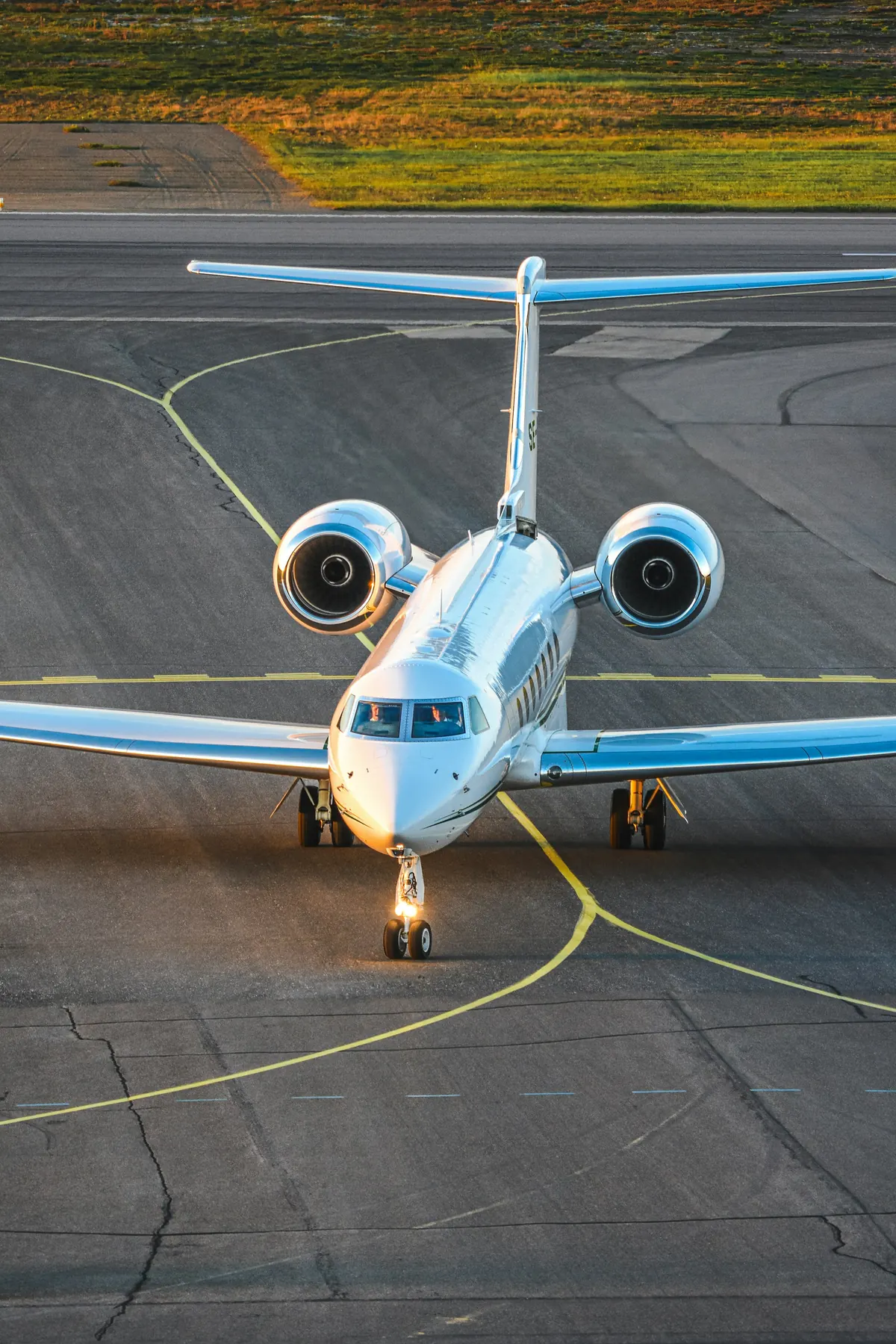 Private jet taxiing towards the camera on a quiet apron